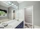 Bright bathroom with dual sinks, large mirror, and a separate room for the toilet at 5640 Rolling Oaks Dr, Cumming, GA 30040