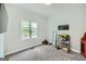 Well-lit bedroom with carpet floors and a large window showcasing the greenery outside at 5640 Rolling Oaks Dr, Cumming, GA 30040