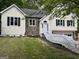 Charming split level home featuring stone accents, white trim, and a two-car garage at 5640 Rolling Oaks Dr, Cumming, GA 30040