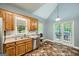 Functional kitchen featuring wood cabinetry, stainless steel appliances, and access to the backyard at 5640 Rolling Oaks Dr, Cumming, GA 30040