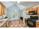 Functional kitchen with wood cabinets, black appliances, and patterned tile flooring at 5640 Rolling Oaks Dr, Cumming, GA 30040