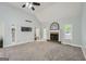 Bright living room with a cozy fireplace, large windows, and neutral carpet at 5640 Rolling Oaks Dr, Cumming, GA 30040