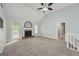 Spacious living room featuring a cozy fireplace, plush carpeting, and access to the outdoors at 5640 Rolling Oaks Dr, Cumming, GA 30040