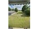 Expansive backyard featuring lush green grass and a view of trees and blue skies at 732 Sandhill Shady Grove Rd, Carrollton, GA 30116