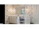 Vintage bathroom featuring unique lighting, floral wallpaper, and vanity with a mirror at 732 Sandhill Shady Grove Rd, Carrollton, GA 30116