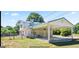 Rear exterior view of a two-story home with a carport and fenced yard at 732 Sandhill Shady Grove Rd, Carrollton, GA 30116