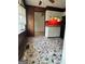 Kitchen featuring white cabinets, white countertops, stone-look flooring and a red accent wall at 732 Sandhill Shady Grove Rd, Carrollton, GA 30116