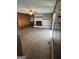 Spacious living room with a fireplace, brick accent wall, and neutral carpet at 732 Sandhill Shady Grove Rd, Carrollton, GA 30116
