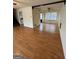 Cozy living room featuring neutral walls, laminate flooring, and staircase at 732 Sandhill Shady Grove Rd, Carrollton, GA 30116