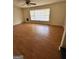 Sunlit living room featuring neutral walls, laminate flooring, and a bay window at 732 Sandhill Shady Grove Rd, Carrollton, GA 30116
