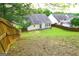 Fenced backyard featuring a patio, ideal for outdoor dining and entertaining, with a well-maintained lawn at 25 Pacific Ave, Sharpsburg, GA 30277