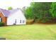 Expansive backyard with ample green space, a fence, and mature trees, perfect for outdoor activities and privacy at 25 Pacific Ave, Sharpsburg, GA 30277
