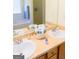 Bathroom with double sinks, framed mirror and basket of fresh towels at 25 Pacific Ave, Sharpsburg, GA 30277