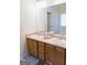 Bathroom featuring a double sink vanity with wood cabinets and a large mirror at 25 Pacific Ave, Sharpsburg, GA 30277