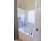 Bright bathroom with a soaking tub and tiled surround, illuminated by a glass block window at 25 Pacific Ave, Sharpsburg, GA 30277