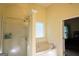 Bright bathroom featuring a soaking tub with glass block window and a separate shower at 25 Pacific Ave, Sharpsburg, GA 30277