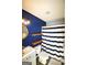 Cozy bathroom with stylish blue accent wall, wood shelving, and modern fixtures at 25 Pacific Ave, Sharpsburg, GA 30277