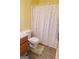 Bright bathroom featuring wood-look vinyl floors and a shower with a patterned curtain at 25 Pacific Ave, Sharpsburg, GA 30277