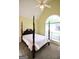 Bedroom with a four-poster bed, large window, and neutral carpet at 25 Pacific Ave, Sharpsburg, GA 30277