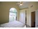 Bedroom featuring a four-poster bed, a vaulted ceiling, and an arched window at 25 Pacific Ave, Sharpsburg, GA 30277
