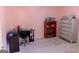 Bedroom featuring neutral carpet, a desk area, and a decorative bookcase at 25 Pacific Ave, Sharpsburg, GA 30277