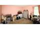Cluttered bedroom with carpet, a window, and a silvery chest of drawers at 25 Pacific Ave, Sharpsburg, GA 30277