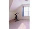 Attic bonus room with carpeting, natural light, exercise bike, and sloped ceilings at 25 Pacific Ave, Sharpsburg, GA 30277