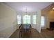 Cozy eat-in kitchen features a bay window and modern light fixture with easy access to the fireplace at 25 Pacific Ave, Sharpsburg, GA 30277