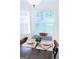 Close up of a table setting in a sunlit dining nook with large windows at 25 Pacific Ave, Sharpsburg, GA 30277