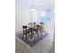 Charming dining area with table set for four, large windows, and a bright light fixture at 25 Pacific Ave, Sharpsburg, GA 30277