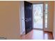 Bright entryway with wood floors, black front door, and sidelight window at 25 Pacific Ave, Sharpsburg, GA 30277