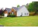 Well-kept home with a combination of brick and siding, complemented by a lush green lawn and landscaping at 25 Pacific Ave, Sharpsburg, GA 30277