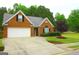 Charming brick home with a well-manicured lawn, featuring a two-car garage and inviting curb appeal at 25 Pacific Ave, Sharpsburg, GA 30277