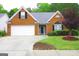 Charming single-Gathering home with a well-manicured lawn, brick facade, and two car garage at 25 Pacific Ave, Sharpsburg, GA 30277