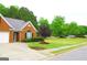 Charming home exterior featuring manicured landscaping and a spacious front lawn at 25 Pacific Ave, Sharpsburg, GA 30277