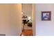 Hallway view leading to a bright living room with a fireplace and neutral colored furniture at 25 Pacific Ave, Sharpsburg, GA 30277