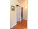 Hallway with hardwood floors leading to rooms, enhanced by light-colored walls at 25 Pacific Ave, Sharpsburg, GA 30277