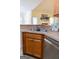 A closer look at the kitchen sink and stainless steel dishwasher shows an eat-in dining area in the background at 25 Pacific Ave, Sharpsburg, GA 30277