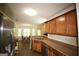 Modern kitchen with stainless steel appliances, and a view into the dining area at 25 Pacific Ave, Sharpsburg, GA 30277