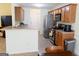 Open concept kitchen with stainless steel appliances, light wood cabinets, and breakfast bar at 25 Pacific Ave, Sharpsburg, GA 30277