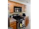 This kitchen features stainless steel appliances and wooden cabinets and drawers at 25 Pacific Ave, Sharpsburg, GA 30277