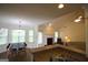 A sunlit living room with fireplace, large windows, and a view of the eat-in kitchen with breakfast nook at 25 Pacific Ave, Sharpsburg, GA 30277
