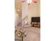 Bright living room with staircase, television on stand, and ceiling fan at 25 Pacific Ave, Sharpsburg, GA 30277