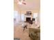 Sunlit living room with fireplace, neutral furniture, ceiling fan, and view to dining area at 25 Pacific Ave, Sharpsburg, GA 30277