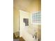Bright main bathroom features a large bathtub, glass block window, and a separate shower at 25 Pacific Ave, Sharpsburg, GA 30277