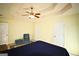 Large main bedroom with a tray ceiling, carpet floors, three closets, and a quaint sitting area at 25 Pacific Ave, Sharpsburg, GA 30277