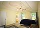 Bright main bedroom with ensuite bathroom and a large window overlooking a lush green backyard at 25 Pacific Ave, Sharpsburg, GA 30277