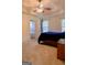 This main bedroom features a tray ceiling with ceiling fan, ensuite bath, and two windows for natural light at 25 Pacific Ave, Sharpsburg, GA 30277