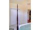 Main bedroom with a four-poster bed, double closets, and an ensuite bath at 25 Pacific Ave, Sharpsburg, GA 30277