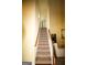 Carpeted staircase with wooden handrail leading to the upper level of the home at 25 Pacific Ave, Sharpsburg, GA 30277